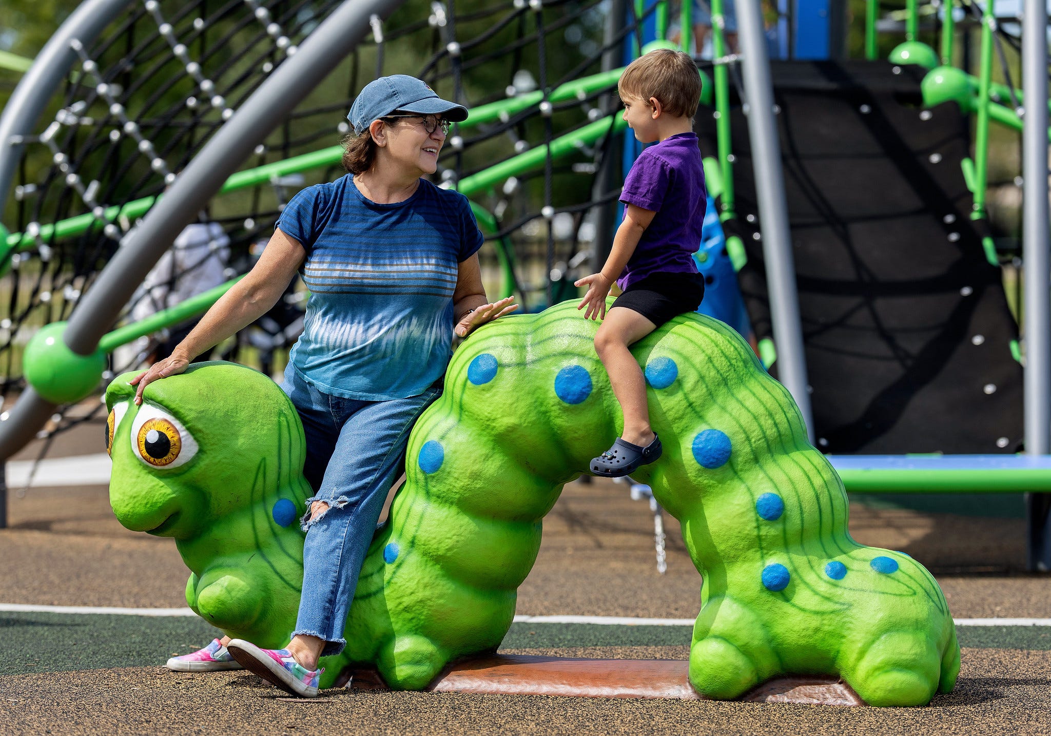 Children playing on a turtle-themed Fun Forms playground sculpture