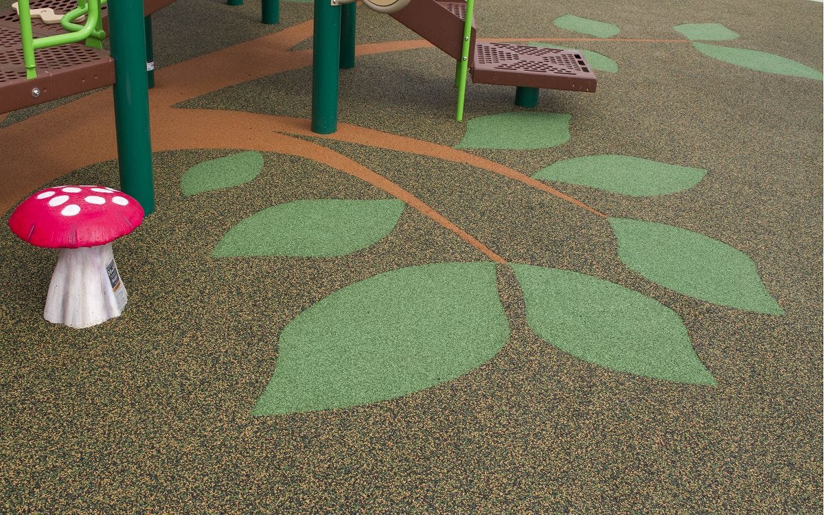 Playground surfacing option with leaf-shaped poured-in-place design