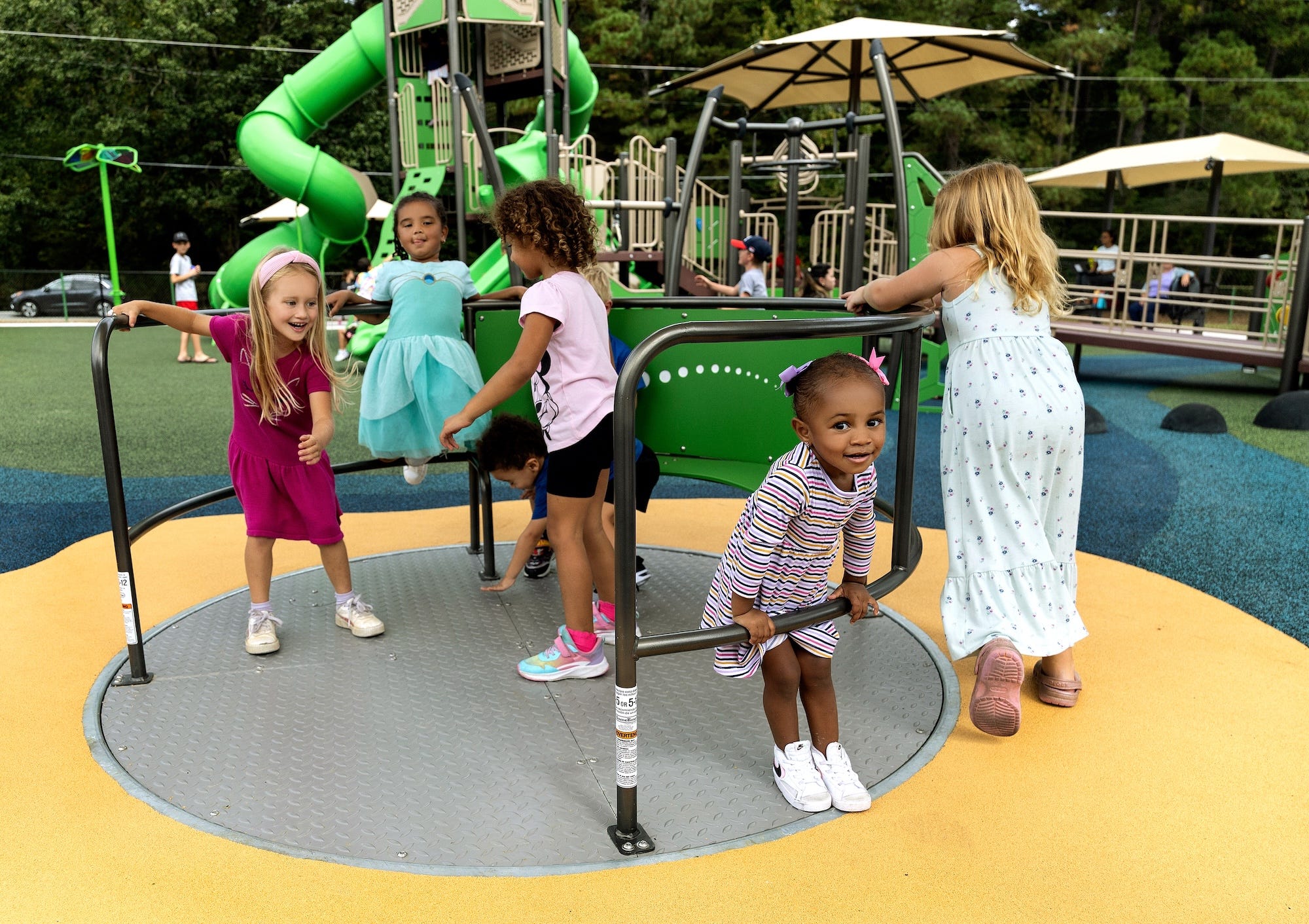 Adaptive mobility device beside swings at Jamestown Park