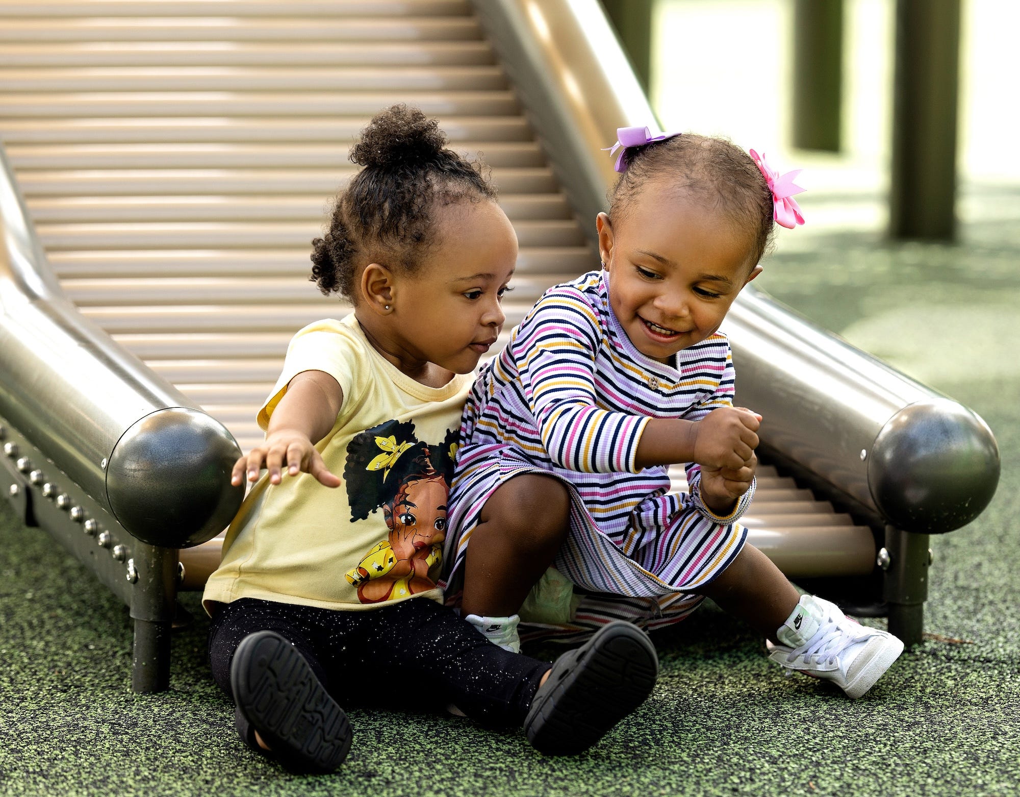 Children playing together on spinning playground equipment at Jamestown Park