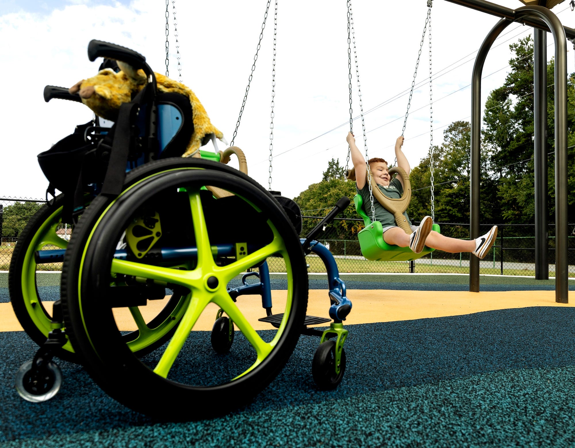 Child using an inclusive swing at Jamestown Park