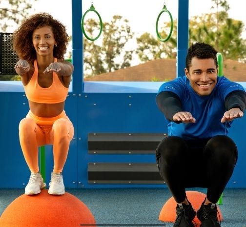 Children and families using an inclusive playground